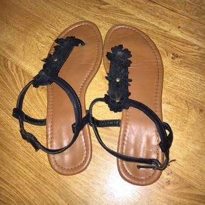 Brown sandals with black flowers